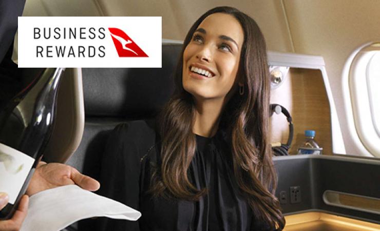 Woman on Qantas flight being served wine