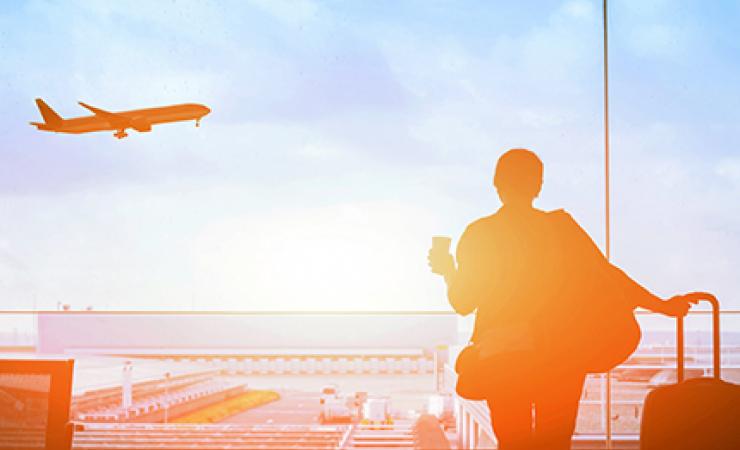 Person in terminal watching plane flying