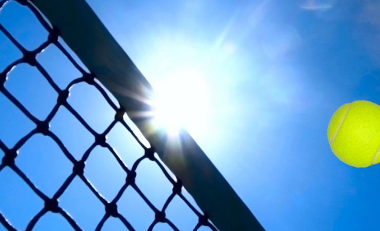 Tennis ball flying over Net