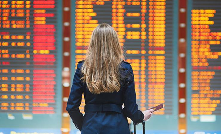 Lady in front of flight board