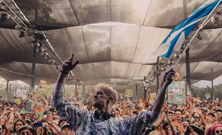 Image of man waving a flag in front of 100's