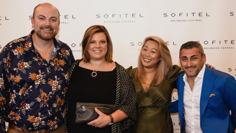 Linh and co-workers at Sofitel event smiling 