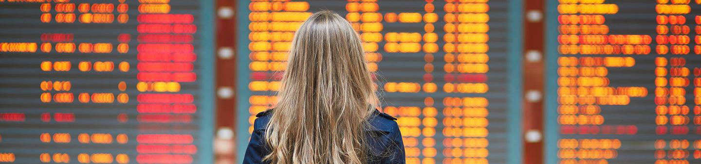 Lady in front of flight board