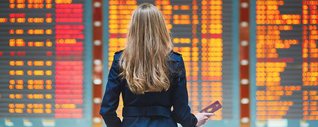 Lady looking at Airport flights notice board