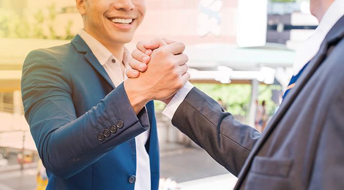 Businessmen handshake partnership