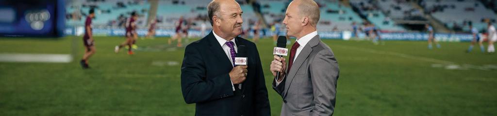 Wally Lewis and Darren Lockyer standing on a rugby league field