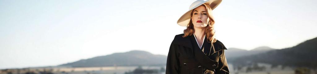 Well dressed lady standing with mountains in background