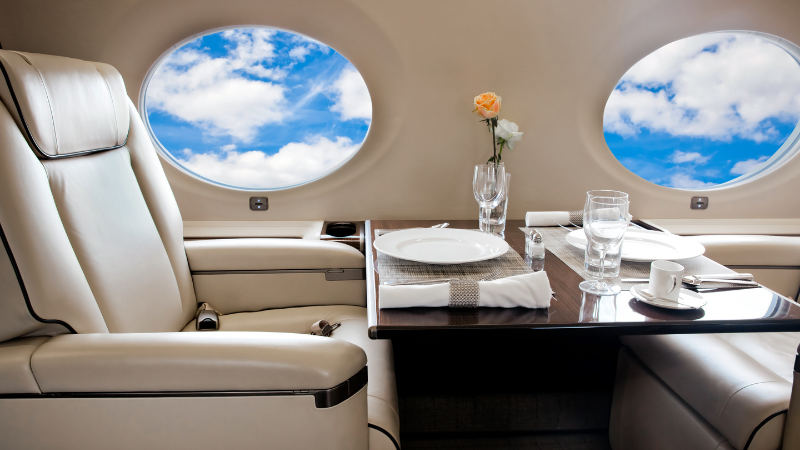 Seat and table in private plan flying in sky