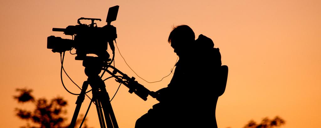 Silhouette of camera man at sunset